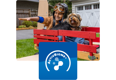 Child playing with dog in wagon
